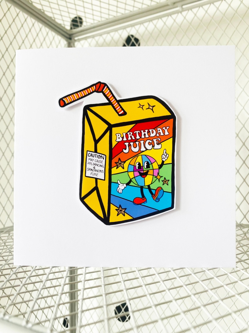 May include: A yellow and red cartoon juice box with a straw. The juice box has the words "Birthday Juice" on it and a cartoon character with a rainbow ball. The text on the juice box says "Caution: May cause 30% dancing & spontaneous fun!"