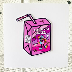 May include: A pink and purple birthday juice box with a cartoon character holding a disco ball. The box has a red and white straw and the text "Birthday Juice" on the front. The text "Caution: May cause joy, dancing & spontaneous fun!" is on the side of the box.