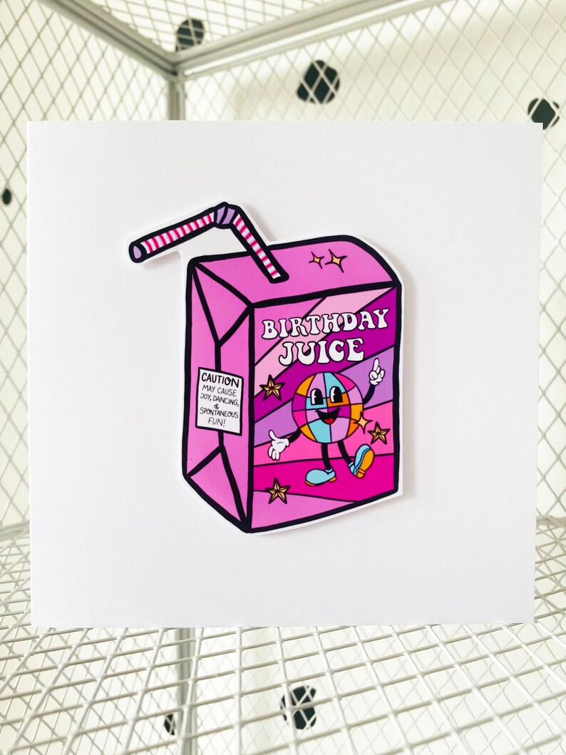 May include: A pink and purple birthday juice box with a cartoon character holding a disco ball. The box has a red and white straw and the text "Birthday Juice" on the front. The text "Caution: May cause joy, dancing & spontaneous fun!" is on the side of the box.