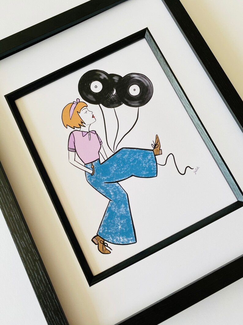 May include: A framed illustration of a woman wearing blue bell bottoms and a pink shirt, holding two black vinyl records as balloons. The woman has short, blonde hair and is smiling. The illustration is signed "Mellie".