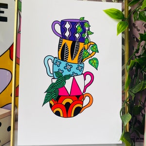 May include: A stack of four colorful mugs with different patterns, including a blue mug with white flowers, a pink and white mug with a geometric design, an orange and black mug with a wavy pattern, and a purple and white mug with a wavy pattern. A green plant with leaves is growing out of the top mug.
