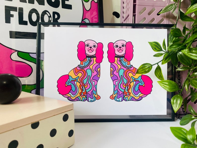 May include: A print of two psychedelic dogs with pink fur, rainbow swirls, and black collars. The dogs are facing forward and have their tongues sticking out.