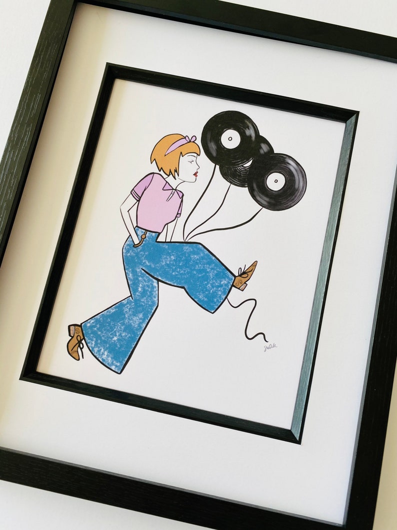 May include: A framed illustration of a woman wearing blue jeans and a pink shirt, holding three black vinyl records as balloons. The woman is walking and smiling. The illustration is signed "jaa".