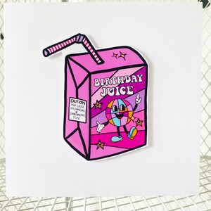May include: A pink and purple juice box with a cartoon disco ball character and the text "Birthday Juice". The juice box has a red and white striped straw.