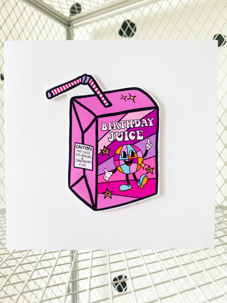 May include: A pink and purple juice box with a cartoon disco ball character and the text "Birthday Juice". The juice box has a red and white striped straw.