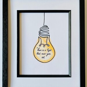 May include: A framed print of a yellow lightbulb with a black wire and the text "There is a light that never goes out".