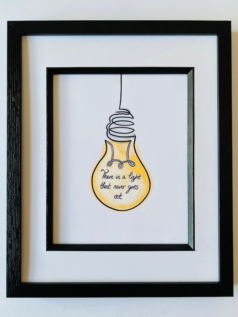 May include: A framed print of a yellow lightbulb with a black wire and the text "There is a light that never goes out".