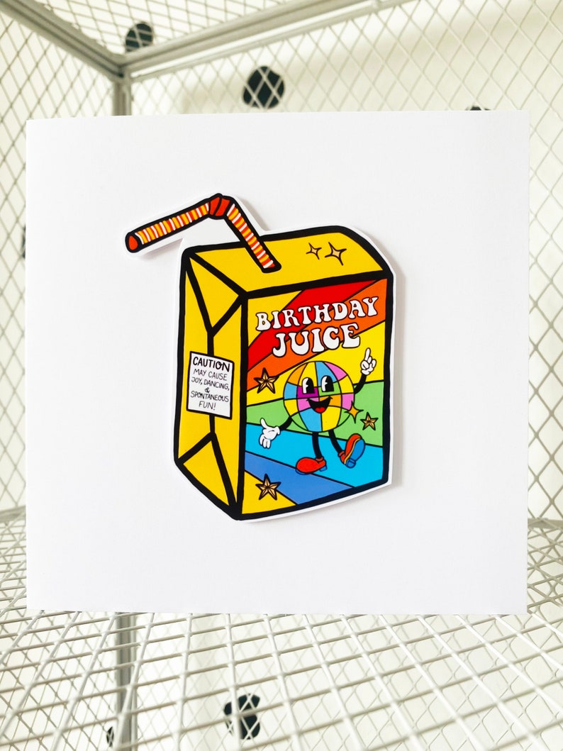 May include: A yellow juice box with a red and orange striped straw. The juice box has a cartoon character on it with a rainbow colored globe for a head and the words "Birthday Juice" on the front. The juice box has a warning label that says "Caution: May cause joy, dancing, & spontaneous fun!"