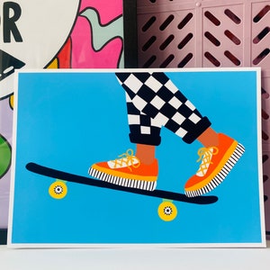 Pu&ograve; includere: Una persona con pantaloni a scacchi neri e bianchi sta facendo skateboard. Indossa scarpe arancioni con strisce nere. Lo skateboard &egrave; blu con ruote gialle.