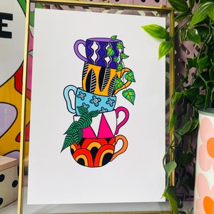 May include: A stack of four colorful mugs with different patterns, including wavy lines, flowers, and geometric shapes. The mugs are stacked on top of each other, with a green plant growing out of the top mug.