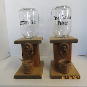May include: Two wooden candy dispensers with glass jars. The jar on the left says "Brandan's Treats" and the jar on the right says "Tara's Survival Pellets!"