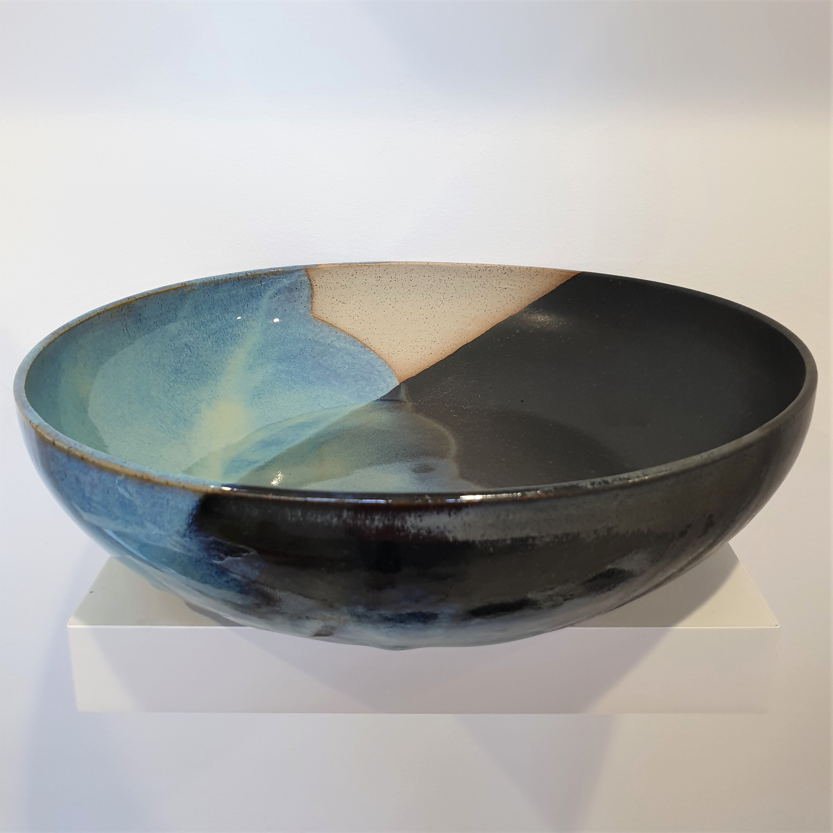 Handmade stoneware serving bowl in black and blue glaze