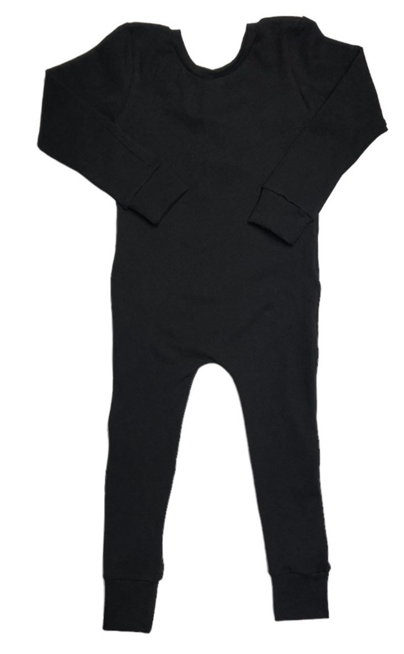 May include: A black long-sleeved jumpsuit with a scoop neck and ribbed fabric.