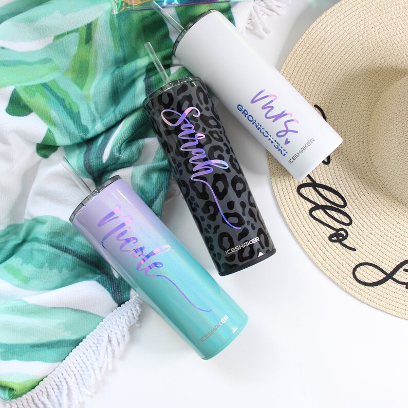 May include: Three stainless steel tumblers with different designs and names. The tumblers are white, black with a leopard print, and a gradient of blue and purple. Each tumbler has a straw and the text "ICESHAKER" on the bottom.