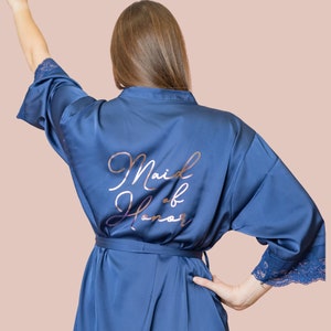 May include: A blue satin robe with a rose gold inscription that reads "Maid of Honor".