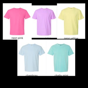 May include: Five t-shirts in different colors: neon pink, lavender, neon yellow, light blue, and light turquoise.