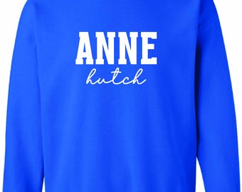 Anne Hutch White Puff on a Unisex Royal Blue Crewneck