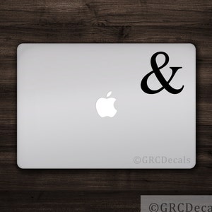 May include: A black ampersand symbol sticker on a silver laptop.