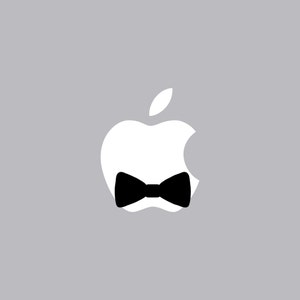 May include: A white apple logo with a black bow tie. The apple is missing a bite.