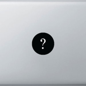 May include: A black circle sticker with a white question mark on a silver laptop.