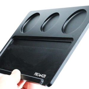 May include: Black rolling tray with three circular indentations and a rectangular section. The tray has the text "PRO 420" printed on the bottom.