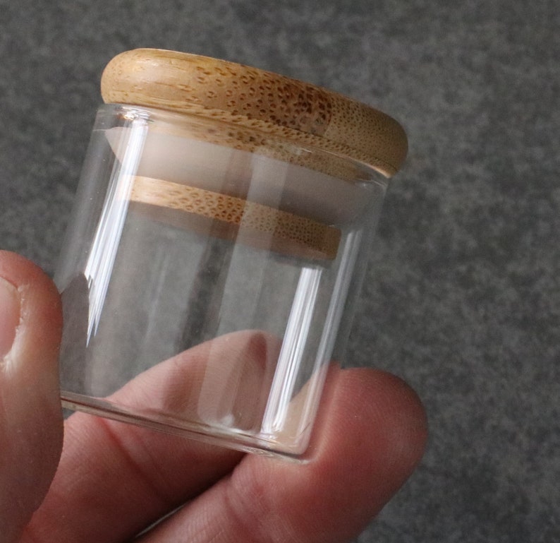 May include: A clear glass jar with a bamboo lid. The lid has a rubber seal to keep the contents fresh.
