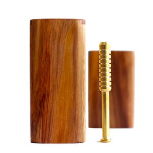 May include: A wooden box with a gold metal poker tool. The box is made of dark wood with a natural grain pattern. The poker tool has a textured surface and a rounded tip.