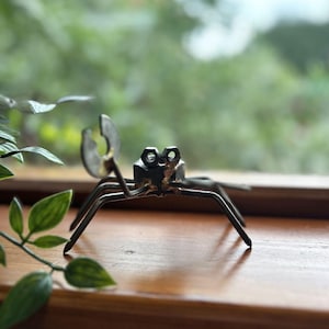 May include: A set of three ceramic nesting bowls in shades of blue, green, and white. The bowls have a speckled glaze and a simple, modern design. The largest bowl is about 15 cm in diameter.