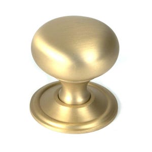 May include: A gold-coloured cabinet knob with a rounded top and a circular base. The knob has a smooth, matte finish and is designed for easy gripping. This hardware is suitable for drawers, cabinets, and other furniture.