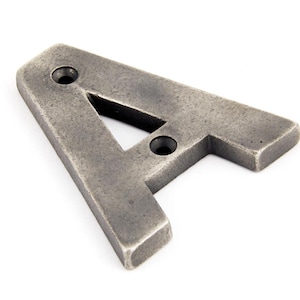 May include: A silver metal letter A with two holes for mounting. The letter is slightly distressed and has a rustic look.