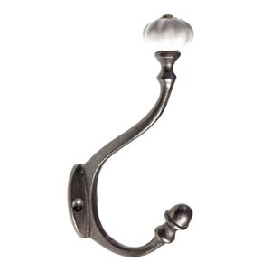 May include: A cast iron hook with a white ceramic knob. The hook is curved and has a decorative acorn-shaped finial at the bottom.