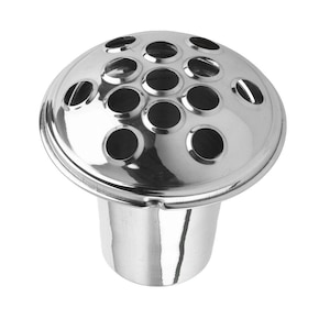 May include: A polished, silver flower frog with a domed top featuring multiple circular holes. It has a cylindrical base, designed to secure flower stems for floral arrangements. The frog is made of metal.