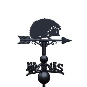May include: Black metal garden weather vane featuring a silhouette of a hedgehog with an arrow pointing to the right. The vane has a compass rose with the directions North, South, East, and West.