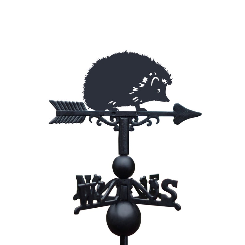 May include: Black metal garden weather vane featuring a silhouette of a hedgehog with an arrow pointing to the right. The vane has a compass rose with the directions North, South, East, and West.