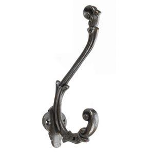 May include: A cast iron hook with a decorative, ornate design. The hook is black and has a curved shape.