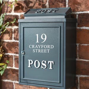 May include: A dark grey metal mailbox with the number 19, the words "Crayford Street" and "POST" on the front.