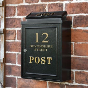 May include: Black metal mailbox with a gold number 12, the words "Devonshire Street" and "POST" in gold lettering.