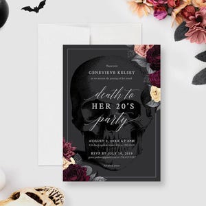 May include: A rectangular invitation card featuring a large black and white skull illustration, dark floral accents, and white text reading Death to Her 20's party, Genevieve Kelsey, August 3, 20XX at 8PM, 326 Buckingham Street, Elyria, OH 44035.