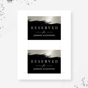 May include: Two black and silver table cards with the text "RESERVED for JOHNSON ACCOUNTING" printed in white.