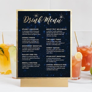 May include: A black and blue sign with gold stars and the text "Drink Menu" on it. The sign lists a variety of drinks with names like "Starry Lemonade", "Cosmic Punch", "Milky Way Milkshake", "Twilight Tonic", "Comet Cooler", "Galaxy Iced Tea", "Nebula Spritzer", "Moonlight Mocktail", "Starlight Smoothie", and "Aurora Borealis Fizz".