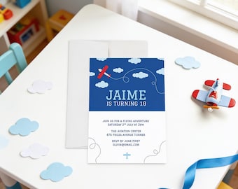 May include: A rectangular birthday invitation card featuring a dark blue top section with a red airplane graphic, white clouds, and the text JAIME IS TURNING 10. The white bottom section includes event details and a small blue airplane icon.