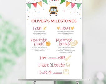 May include: A white milestone poster titled OLIVER'S MILESTONES featuring a yellow school bus, colorful bunting, and confetti. It lists abilities, loves, favorite foods, books, 34 inches tall, 16 teeth, and 35 pounds in red and black text.