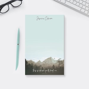 May include: A light blue notepad with a mountain landscape and the text "This is where you'll find me" at the bottom. The name "Jasmine Coleman" is printed at the top of the notepad.
