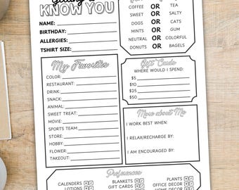 May include: A black and white printable worksheet titled "Getting to Know You." The worksheet includes fill-in sections for personal information, preferences, and "This or That?" questions. A pen, coffee cup, and plant are on the wooden surface.