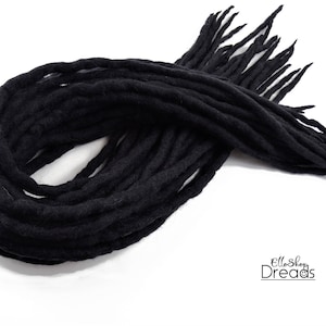 May include: A bundle of black wool dreadlocks, approximately 20 inches long. The dreadlocks are soft and textured, and they are perfect for adding a touch of bohemian style to any look.