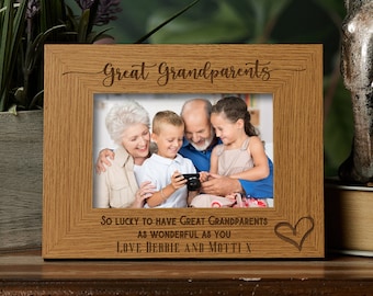 May include: A wooden photo frame with a light brown finish. The frame has a cutout heart and the text "Great Grandparents" and "So lucky to have great grandparents as wonderful as you. Love Debbie and Motti X".