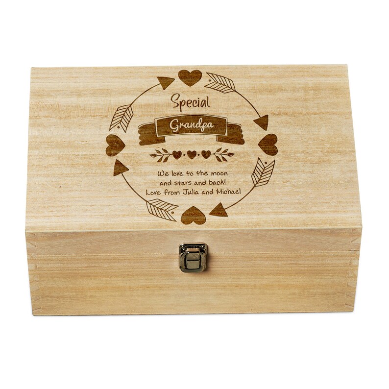 May include: A wooden box with a hinged lid and a latch. The lid is engraved with the words "Special Grandpa" in a circle with arrows and hearts. The text below reads "We love to the moon and stars and back! Love from Julia and Michael."
