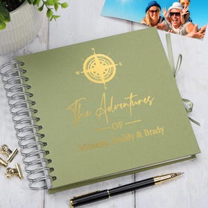 May include: A green spiral bound photo album with a gold compass design and the text "The Adventures of Mummy, Daddy & Brady".