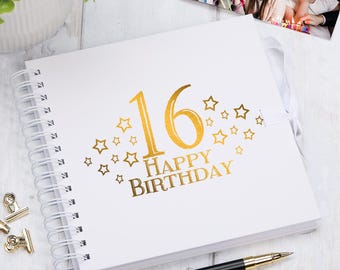 May include: White spiral bound photo album with a gold foil design. The cover features the number 16, the words "Happy Birthday" and a scattering of gold stars.