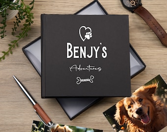 Könnte beinhalten: Schwarzes Fotoalbum mit einem weißen Herz- und Pfotenabdruck-Design. Das Album sagt "BENJY'S Adventures" mit einer Knochengrafik unter dem Text. Das Album ist geöffnet und zeigt ein Foto eines Golden Retrievers.